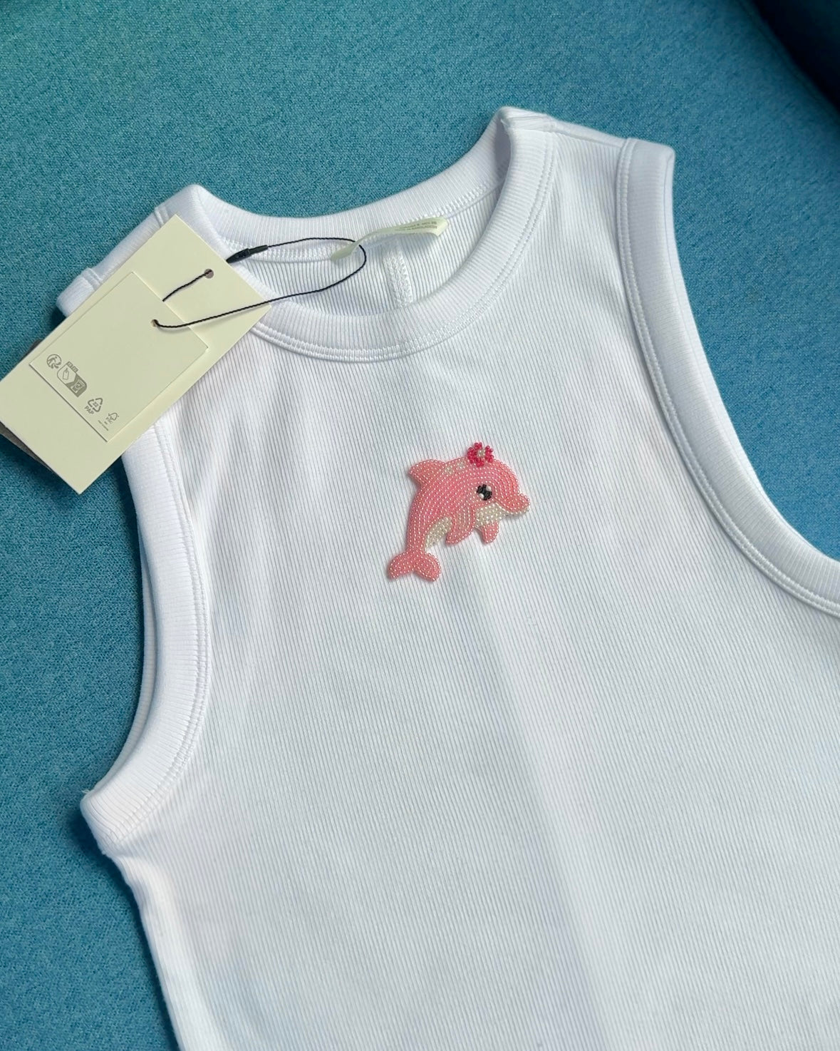 Original white ribbed tank top with pink beaded dolphin motif