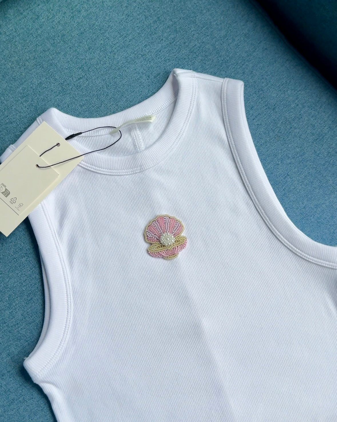 Original white ribbed top with pink beaded shell and pearl-like centre