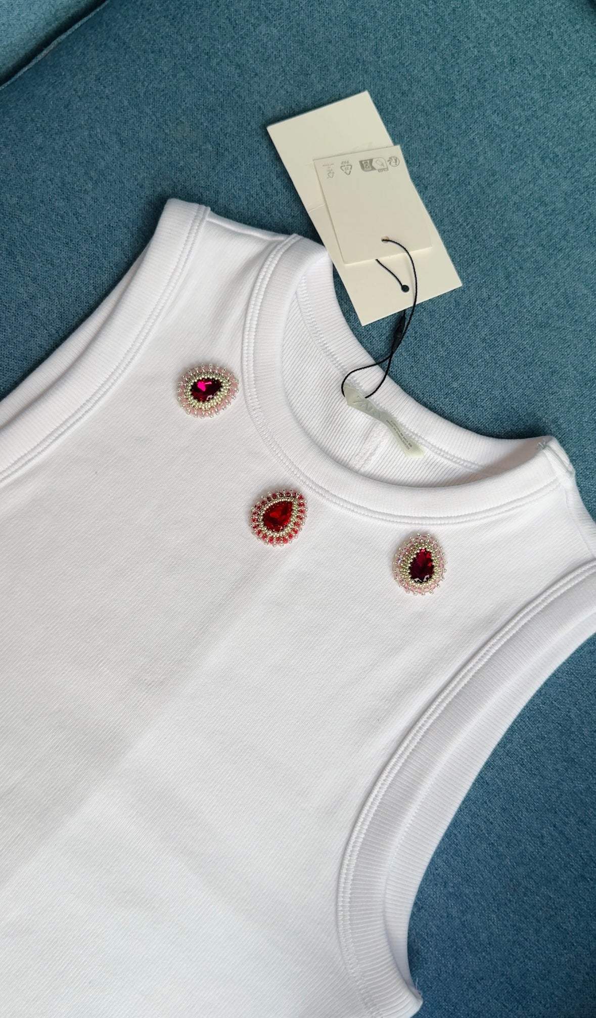 White Ribbed Top with Three Red and Pink Gemstones